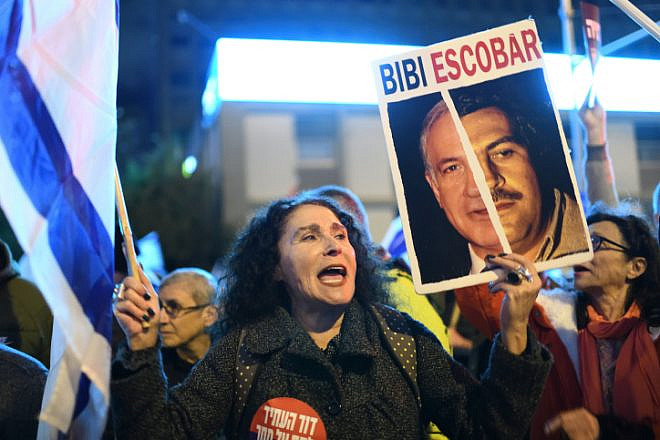 A protester in Tel Aviv waves a placard comparing Prime Minister Benjamin Netanyahu to the late Colombian drug lord and narcoterrorist Pablo Escobar, Feb. 4, 2023. Photo by Gili Yaari /Flash90.