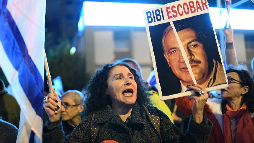 A protester in Tel Aviv waves a placard comparing Prime Minister Benjamin Netanyahu to the late Colombian drug lord and narcoterrorist Pablo Escobar, Feb. 4, 2023. Photo by Gili Yaari /Flash90.