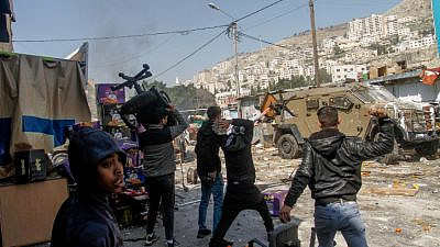 Palestinians attack Israeli security personnel during a counter-terrorism operation in Nablus, Feb. 22, 2023. Photo by Nasser Ishtayeh/Flash90.