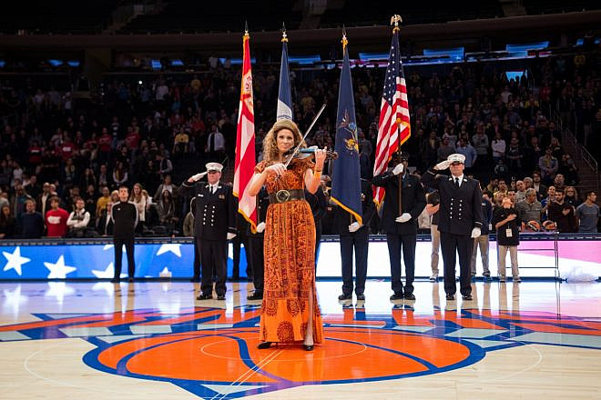 The violinist Miri Ben-Ari performs during the Euro Classic between Maccabi FOX Tel-Aviv and EA7 Armani Milano in Madison Square Garden in New York City on Oct. 4, 2015. Credit: Shutterstock.