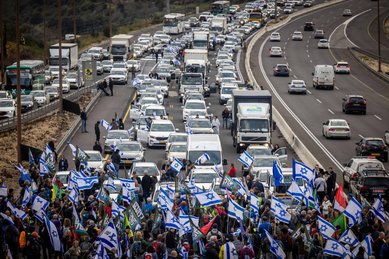 Reservists and veterans from the Israel Defense Forces, in addition to activists, block Road 1, the main highway to Jerusalem, during a protest against the government's planned judicial reforms, Feb. 9, 2023. Photo by Yonatan Sindel/Flash90.