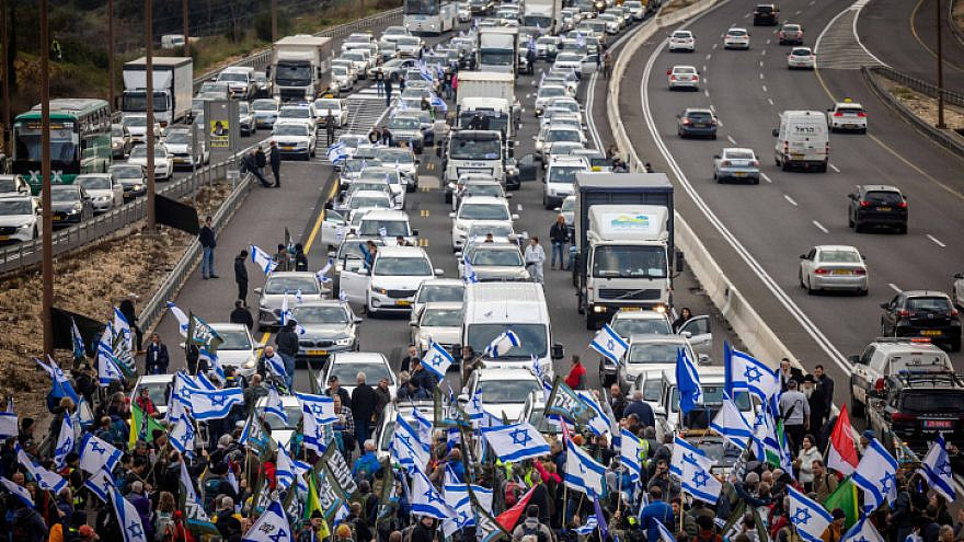 Reservists and veterans from the Israel Defense Forces, in addition to activists, block the main highway to Jerusalem, Road 1, near Abu Gosh, during a protest against the government's planned reforms, Feb. 9, 2023. Photo by Yonatan Sindel/Flash90.