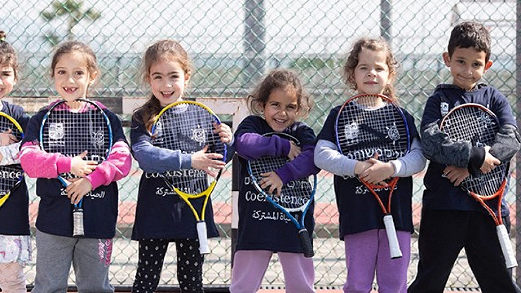 Players from the Israel Tennis & Education Centers wear coexistence-themed shirts. Credit: Israel Tennis & Education Centers.