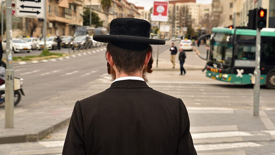 A haredi Jewish man waits for a traffic light on Jaffa Street in Mekor Baruch neighborhood in Jerusalem. Credit: defotoberg/Shutterstock.