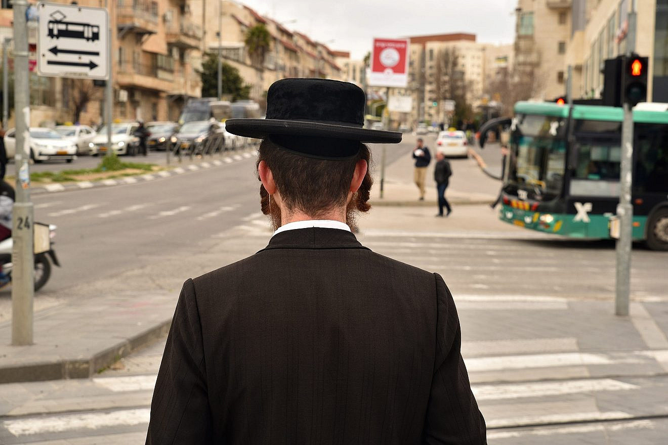 A haredi Jewish man waits for a traffic light on Jaffa Street in Mekor Baruch neighborhood in Jerusalem. Credit: defotoberg/Shutterstock.