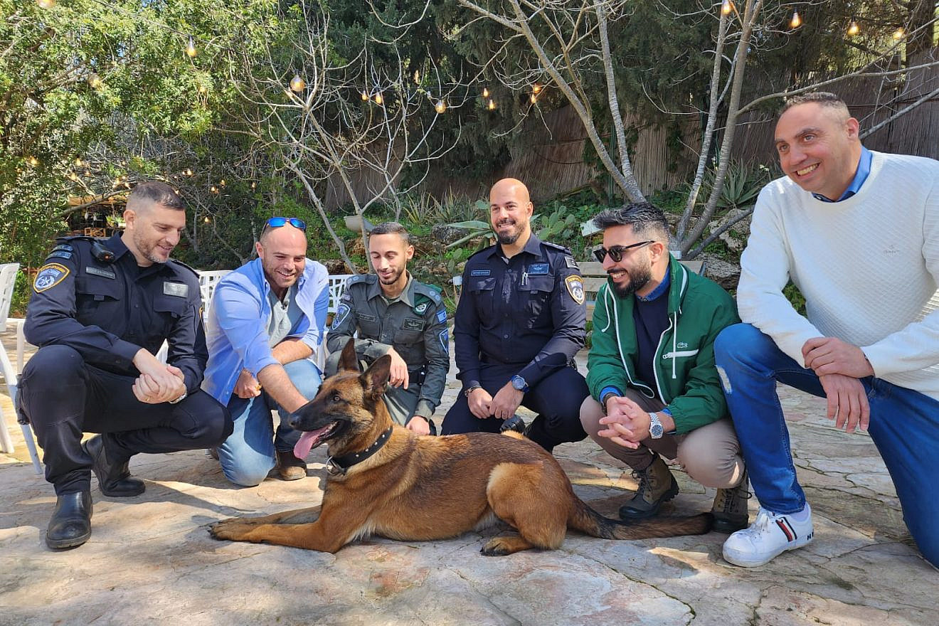 Maor (second from left) and the police officers who reunited him with Jila. Credit: Israel Police.