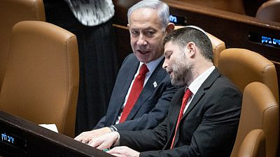Israeli Prime Minister Benjamin Netanyahu speaks with Finance Minister Bezalel Smotrich during a discussion and a vote on the government's judicial overhaul plans in the Knesset assembly hall, on Feb. 20, 2023. Photo by Yonatan Sindel/Flash90.