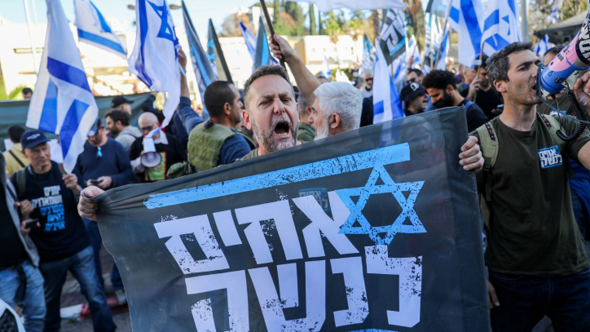 An Israel Defense Forces reservist from the Brothers in Arms protest group attends a demonstration against judicial reform in Bnei Brak, near Tel Aviv, March 16, 2023. Photo by Flash90.
