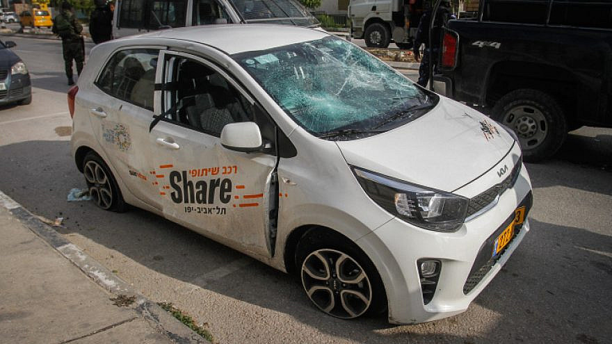 Palestinian police stand next to an Israeli sharing car driven by German tourists, attacked by Palestinian youth in Shechem (Nablus) in northern Samaria on March 18, 2023. Photo by Nasser Ishtayeh/Flash90.