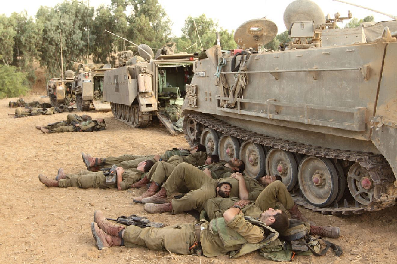 IDF reservists sleep near armored personnel carriers at the Gaza border, on the eighth day of "Operation Protective Edge," July 15, 2014. Photo by Yossi Aloni/Flash90.