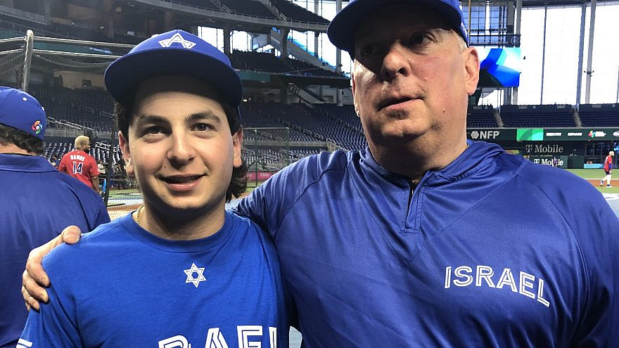 Jordan Gladstone, a batboy for Team Israel, and his father Adam Gladstone, who works in operations for the team, at the World Baseball Classic on March 13, 2023 in Miami. Photo by Howard Blas.