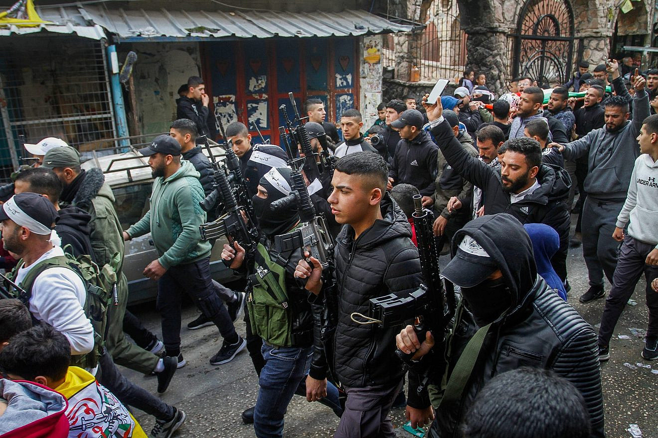 Palestinians, many of them armed, attend a funeral of 16-year-old Muntasir al-Shawa, who was killed during clashes with Israeli security forces in the Balata refugee camp in the West Bank city of Nablus, Feb. 21, 2023. Photo by Nasser Ishtayeh/Flash90.