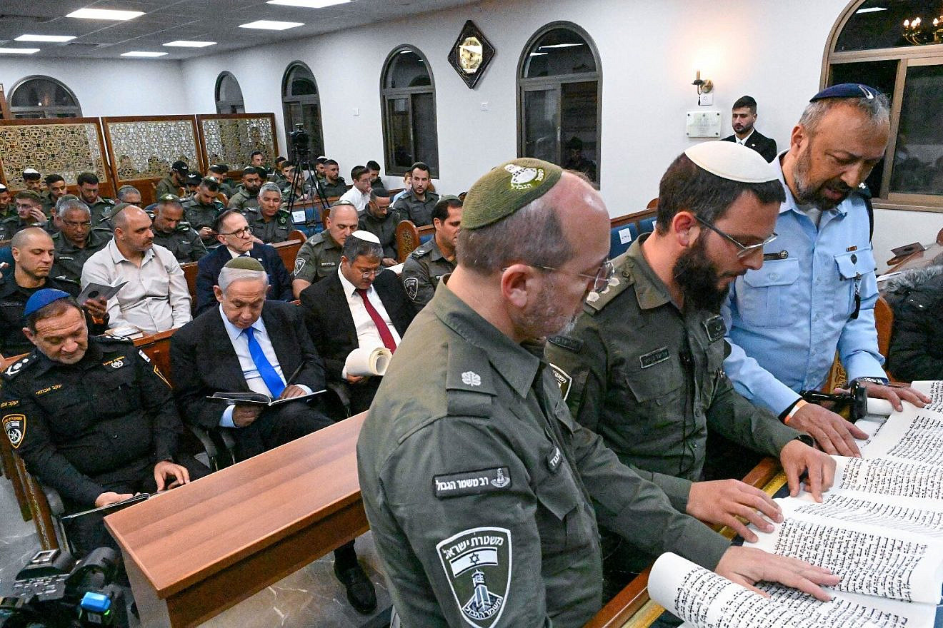 Israeli Prime Minister Benjamin Netanyahu and National Security Minister Itamar Ben-Gvir (both seated) attend a Scroll of Esther reading for Purim at a synagogue at the Beit Horon Border Police base, March 6, 2023. Photo by Kobi Gideon/GPO.