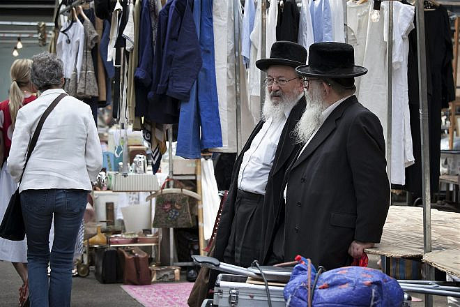 Orthodox Jewish men chat in Spitalfields Market in East London. Credit: Elena Rostunova/Shutterstock.