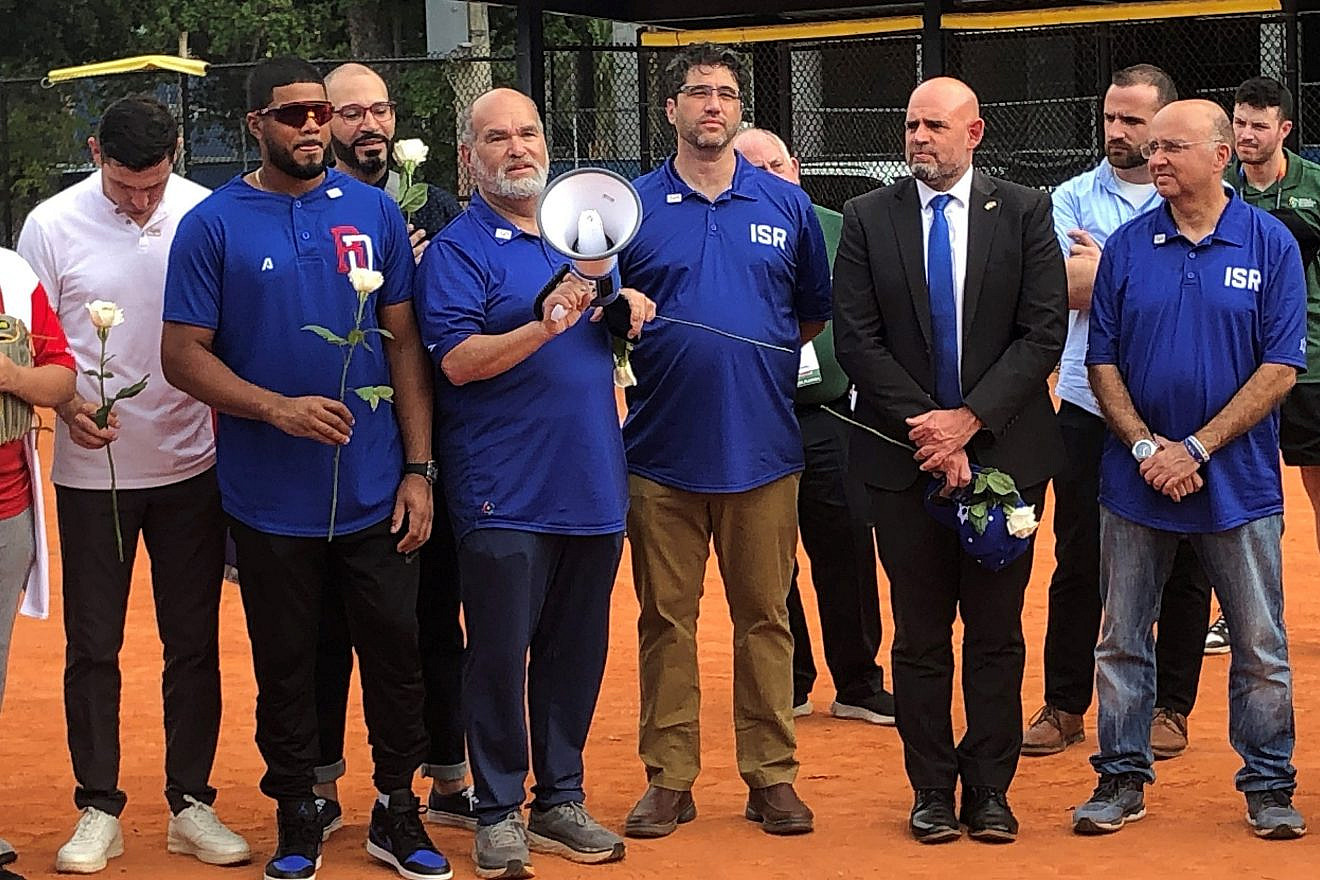 At left is Israel Baseball team manager Ian Kinsler; next to him is general manager of the Dominican Republic team Nelson Cruz (with flower); and Jordy Alpert, president of Israel Baseball (with bullhorn) on March 14, 2023. Photo by Howard Blas.