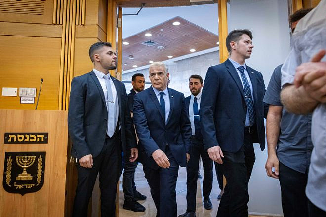 Then-Prime Minister Yair Lapid enters a meeting of his Yesh Atid Party at the Knesset, Dec. 5, 2022. Photo by Olivier Fitoussi/Flash90.