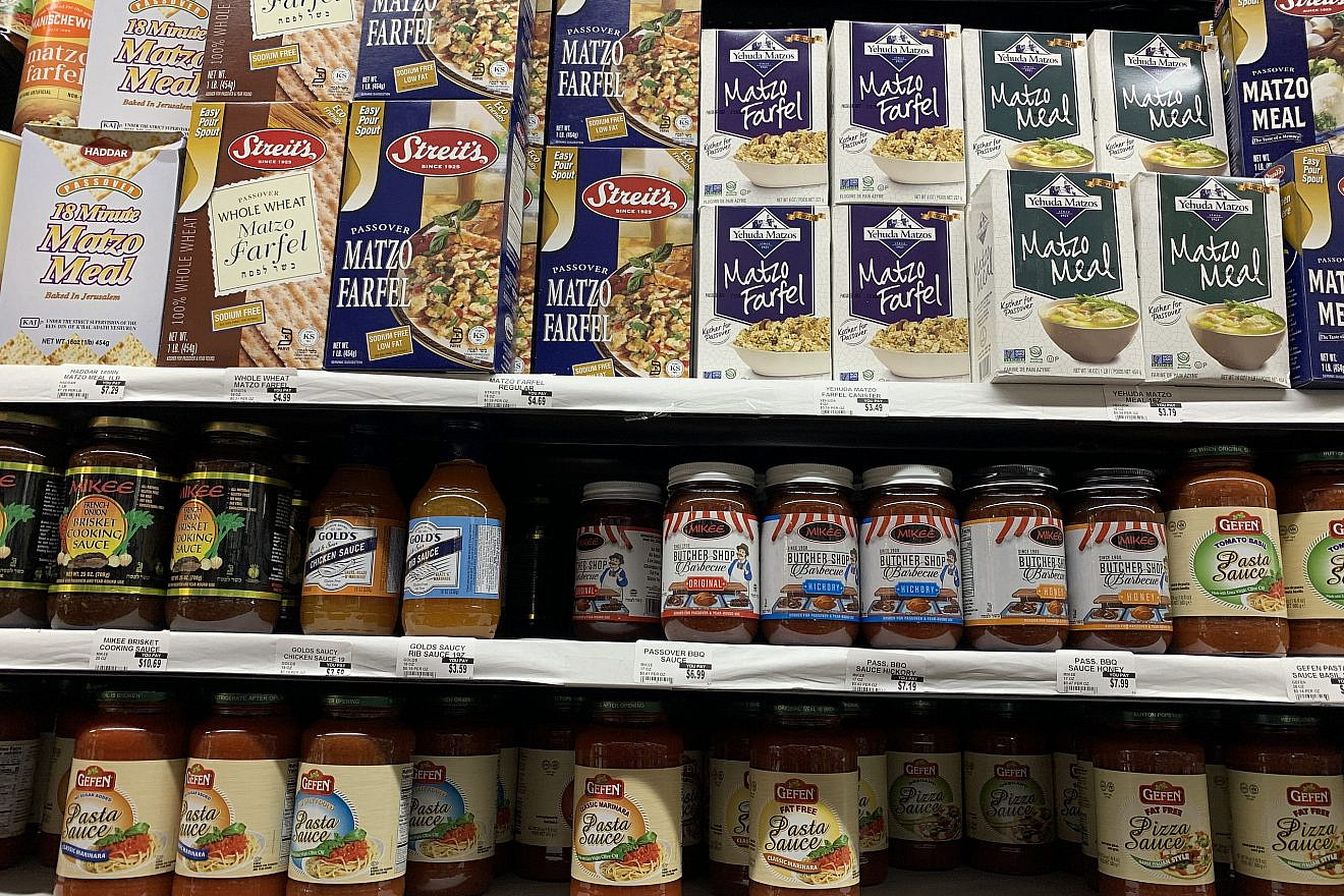 Traditional Passover basics like matzah meal and farfel share shelf space with trendier food items such as sauces and seasonings. Photo by Faygie Holt.