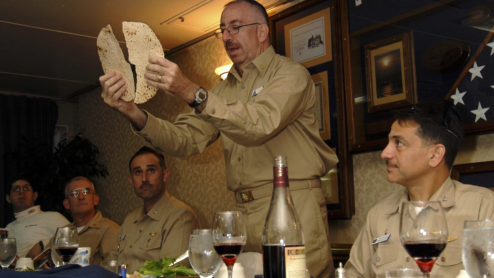 Herman “Herm” Shelanski (far right), then skipper of the squadron on the “USS John C. Stennis,” celebrating Passover in 2008 on the ship with chaplain Rabbi Irving Elson (holding matzah) and executive officer Capt. Ron Reis (next to the left). Credit: Courtesy of Vice Adm. (Ret.) Herman Shelanski.