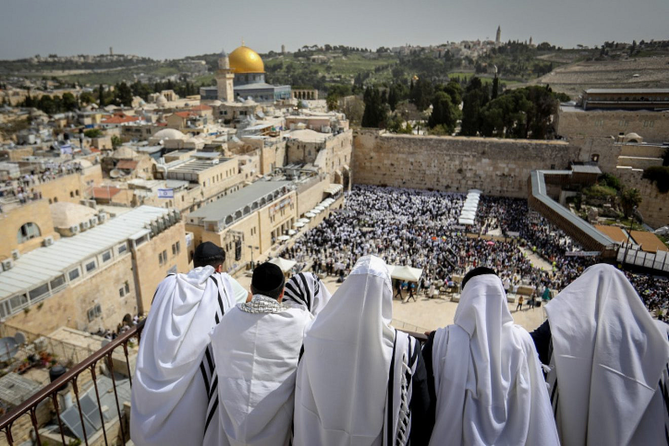 Jewish worshippers cover themselves with prayer shawls during the Passover priestly blessing near the Western Wall in the Old City of Jerusalem on April 9, 2023. Photo by Noam Revkin Fenton/Flash90.