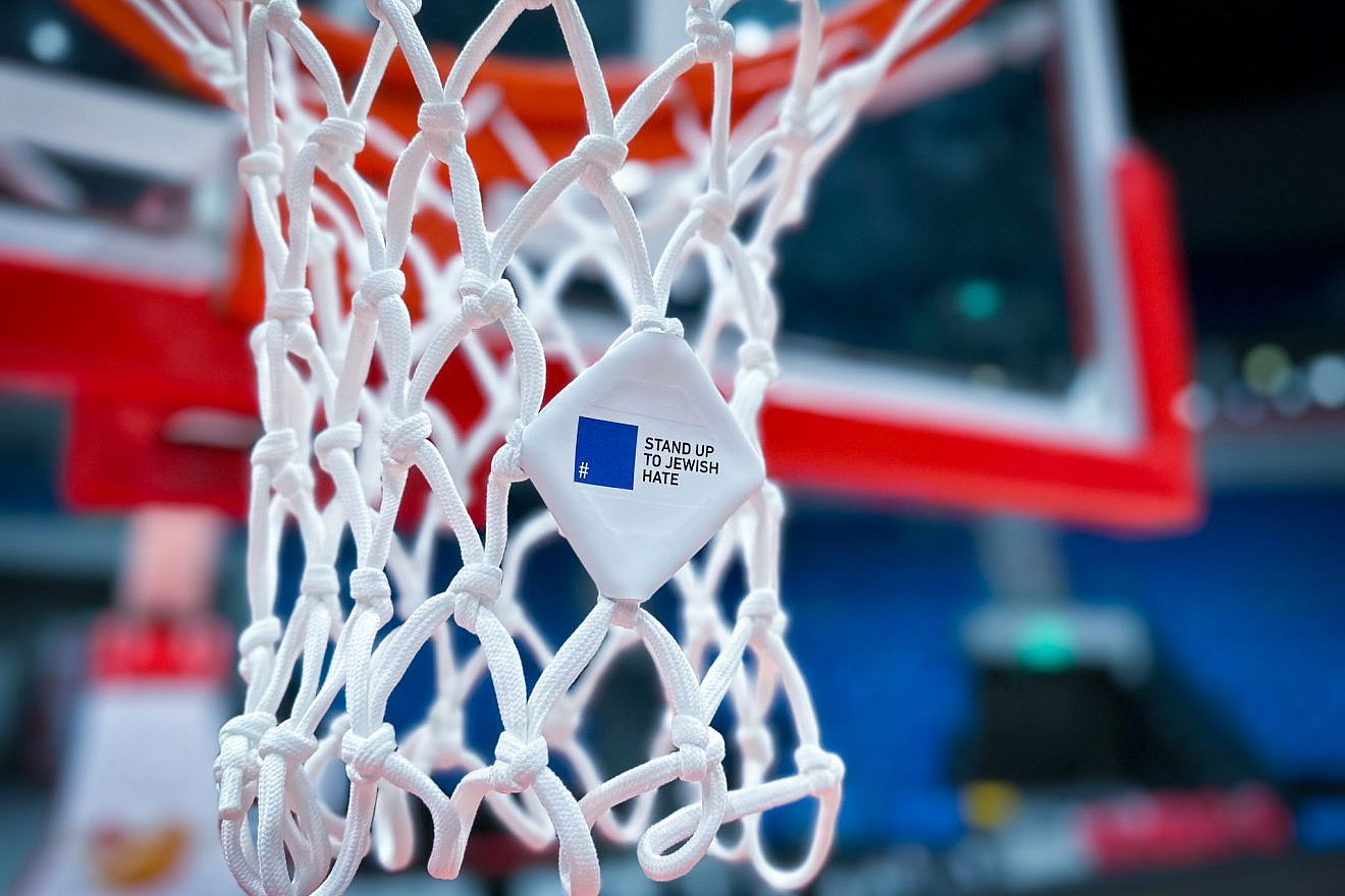 Aviv sports company participates in the #StandUpToJewishHate campaign by hanging the blue square symbol on basketball nets in the Pais Arena in Jerusalem, April 2023. Credit: Courtesy.