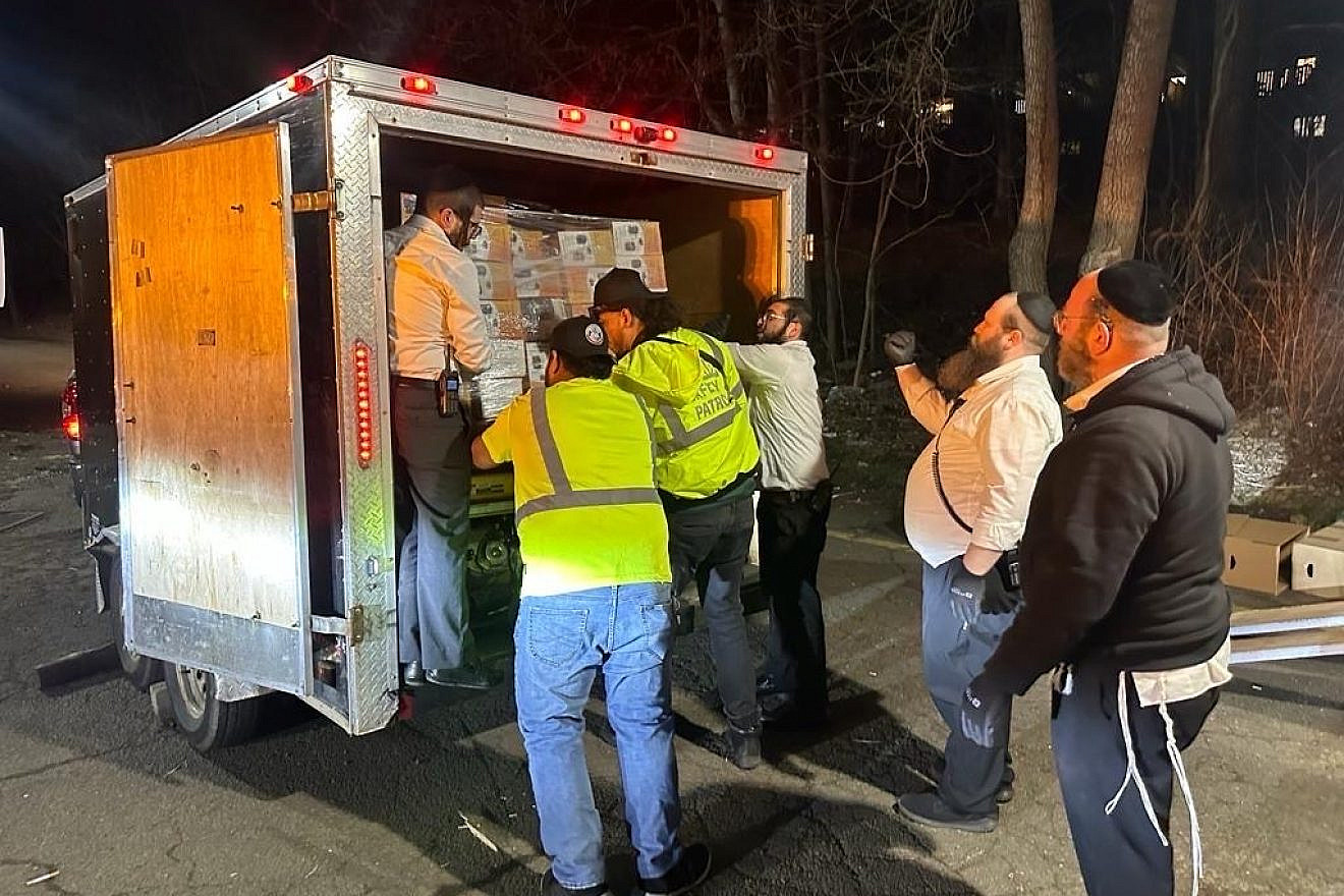 Acting on a rabbinic dispensation, members of Chaverim of Rockland in New York load up a truck with emergency supplies on the second night of Passover to ship to Jews in Montreal, hit by power outages amid an ice storm, April 6, 2023. Credit: Courtesy. (Photographer was not Jewish.)