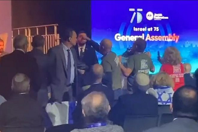 Anti-reform activists harass Knesset member Simcha Rothman at the JFNA General Assembly in Tel Aviv, April 24, 2023. Source: Twitter screenshot.