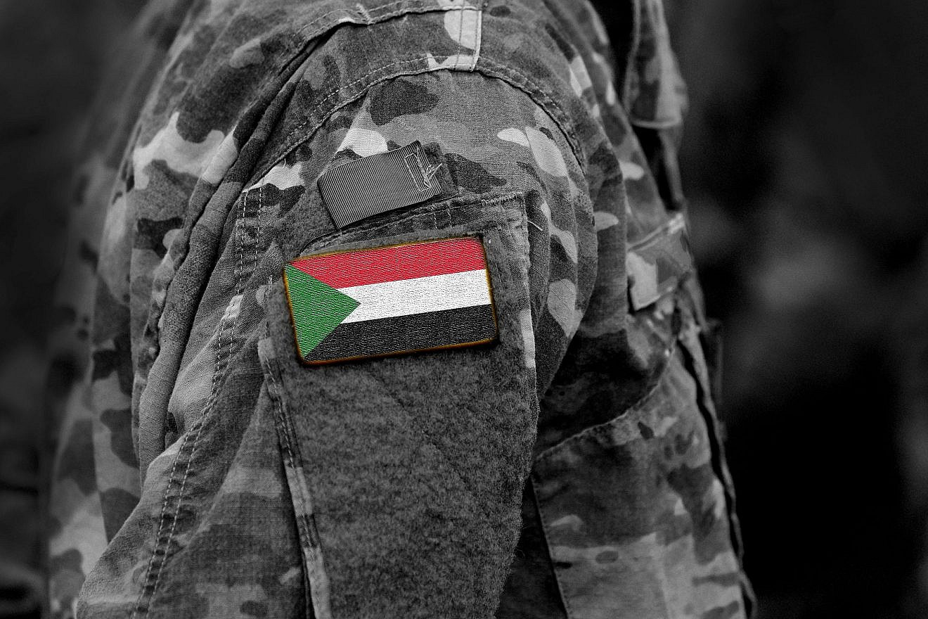 Sudan flag on a military uniform. Credit: Bumble Dee/Shutterstock.