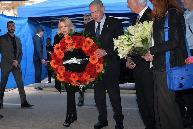 Israeli Prime Minister Benjamin Netanyahu and his wife, Sara, lay a wreath at the site of a car-ramming attack in Tel Aviv, April 16, 2023. Photo by Amos Ben-Gershom/GPO.
