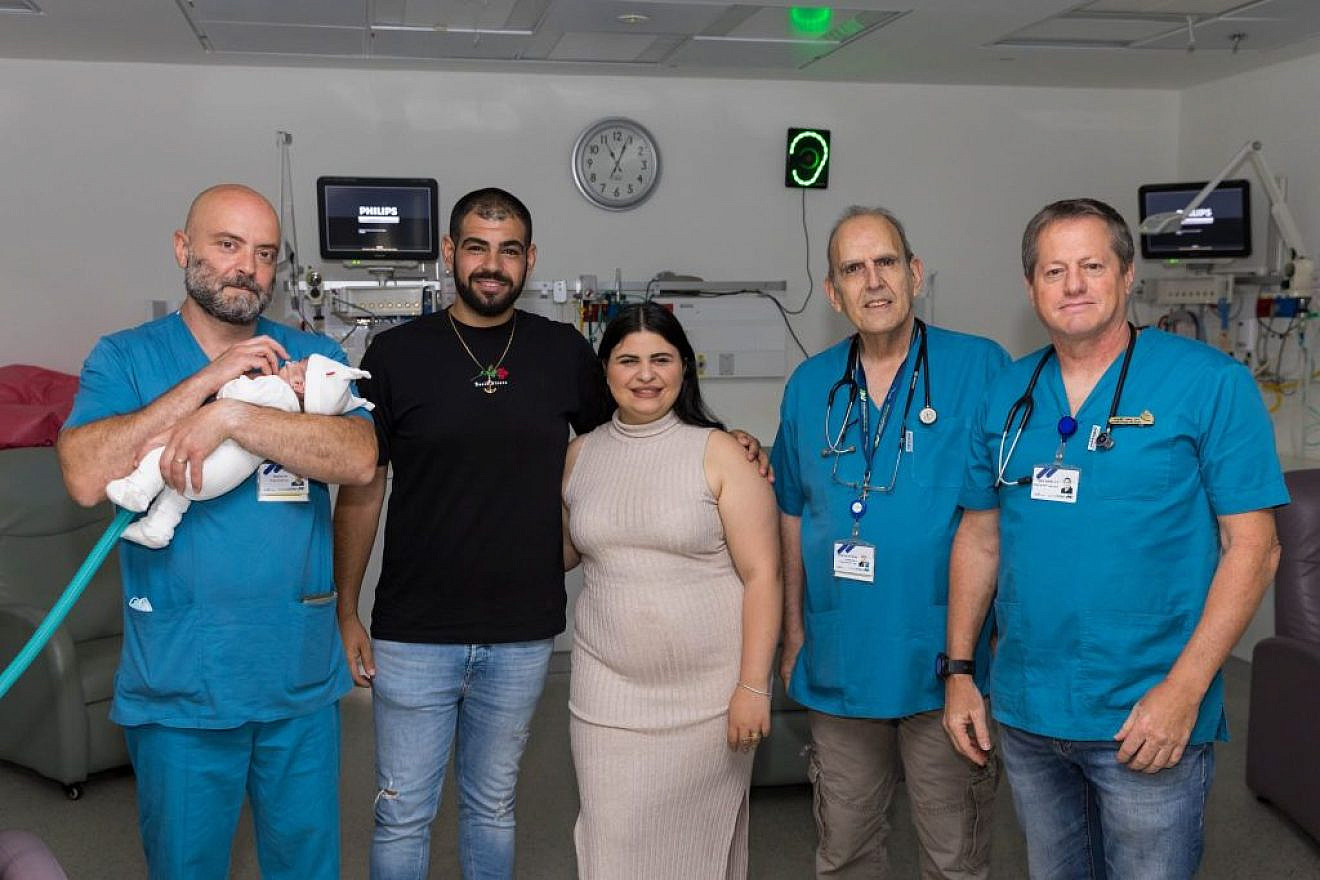 Parents Amir and Yuval Ganeh with their baby son and doctors at Assuta Ashdod Hospital, May 22, 2023. Credit: Assuta Ashdod Hospital.