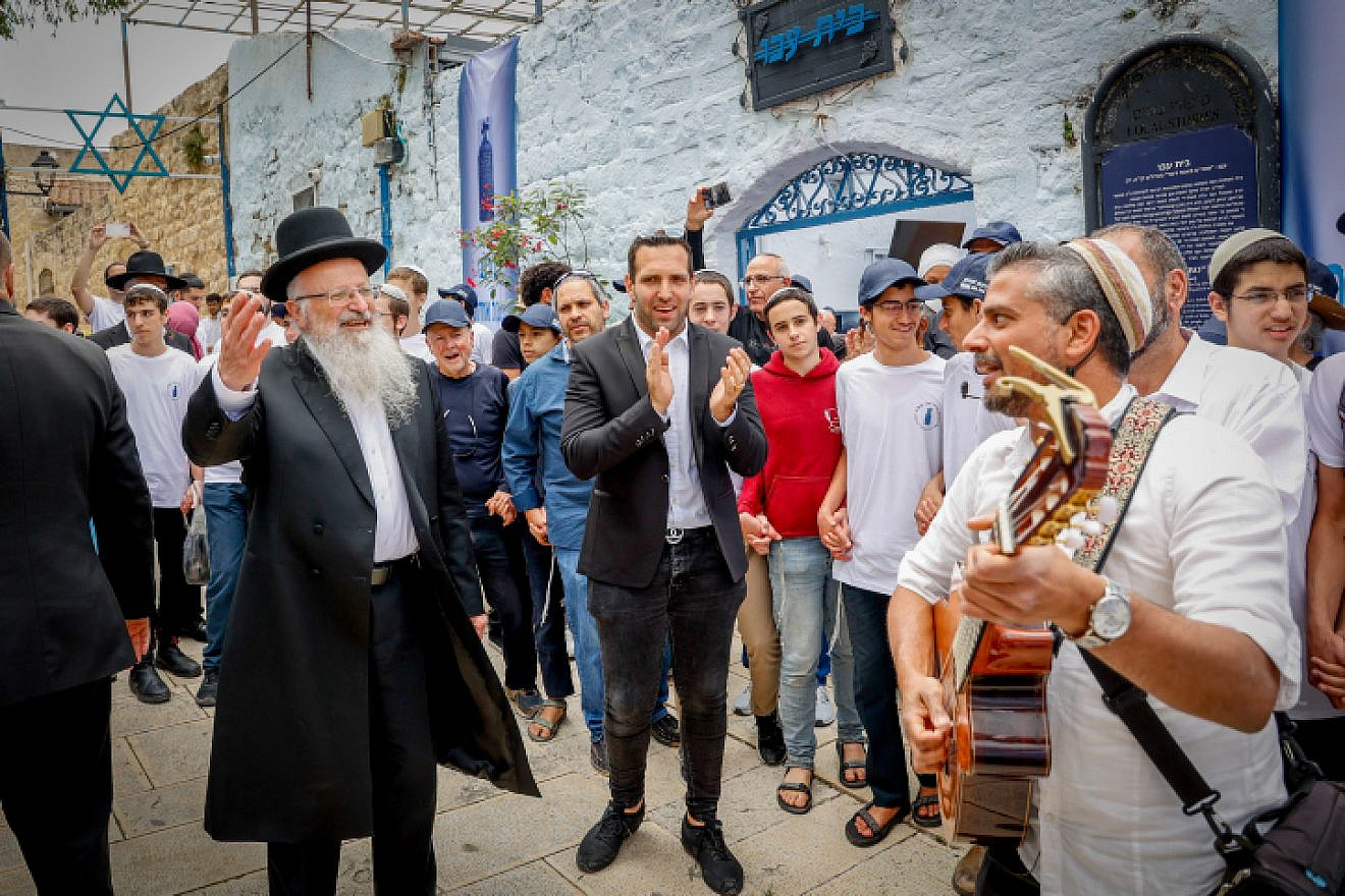 Tzfat's Mayor Shuki Ohana and Chief Rabbi Shmuel Eliyahu dance during the opening of the Lag B'Omer celebrations in the Galilee city, May 8, 2023. Photo by Gershon Elinson/Flash90.