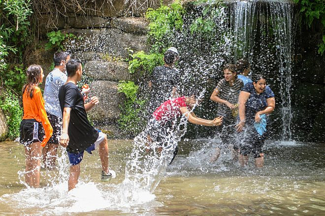 Israelis play in the springs and waterfalls of Snir Park in the Snir Valley, near the Jordan River, May 22, 2023. Photo: Ayal Margolin/FLASH90