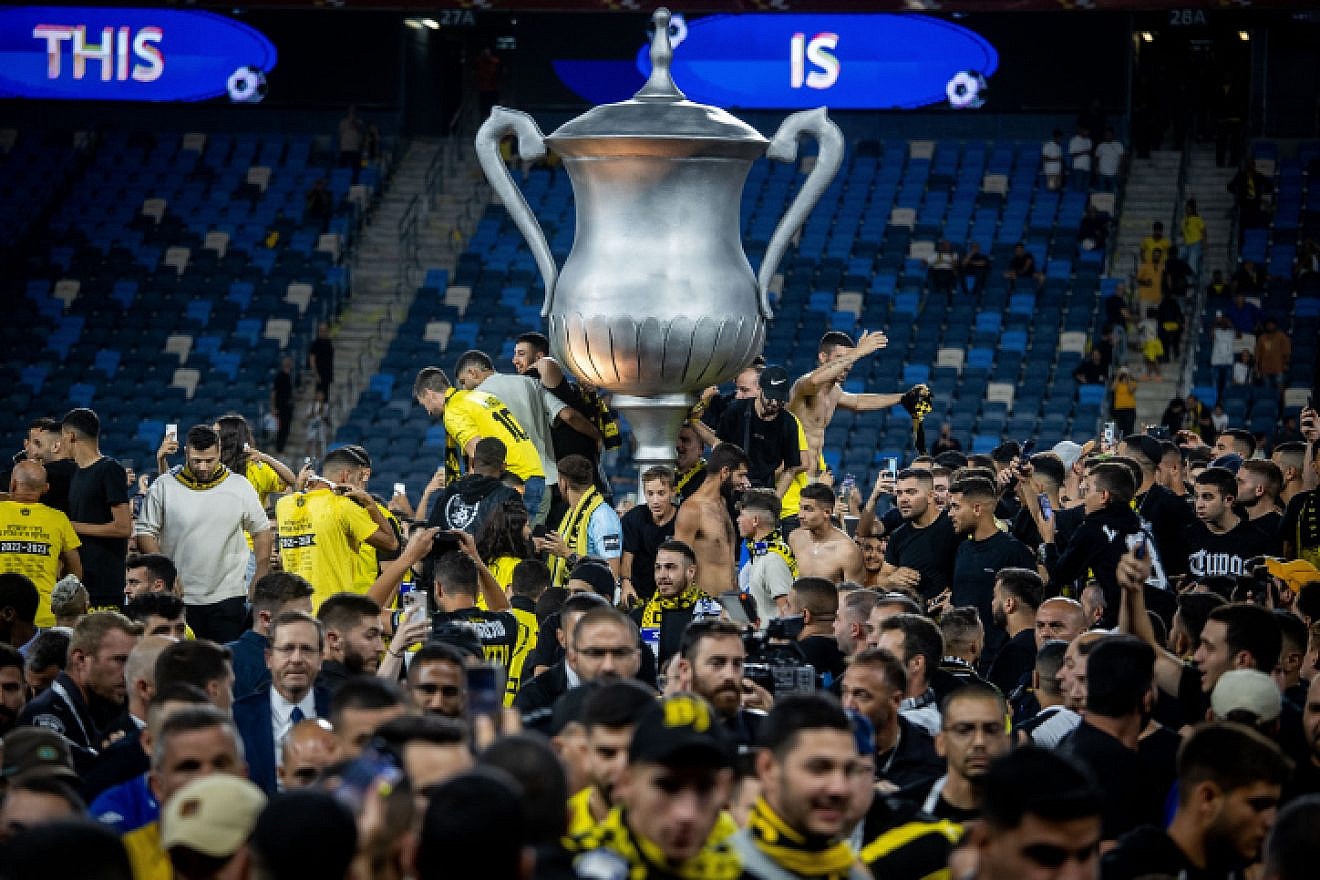 Beitar Jerusalem fans storm the field after the club's victory over Maccabi Netanya to take the Israel State Cup at the Sammy Ofer Stadium in Haifa, May 23, 2023. Photo by Oren Ben Hakoon/Flash90.
