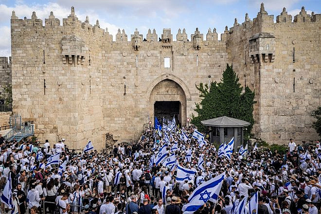 Jewish men hold Israeli flags as they enter the Damascus Gate in Jerusalem's Old City, during Jerusalem Day celebrations on May 18, 2023. Photo by Yonatan Sindel/Flash90.