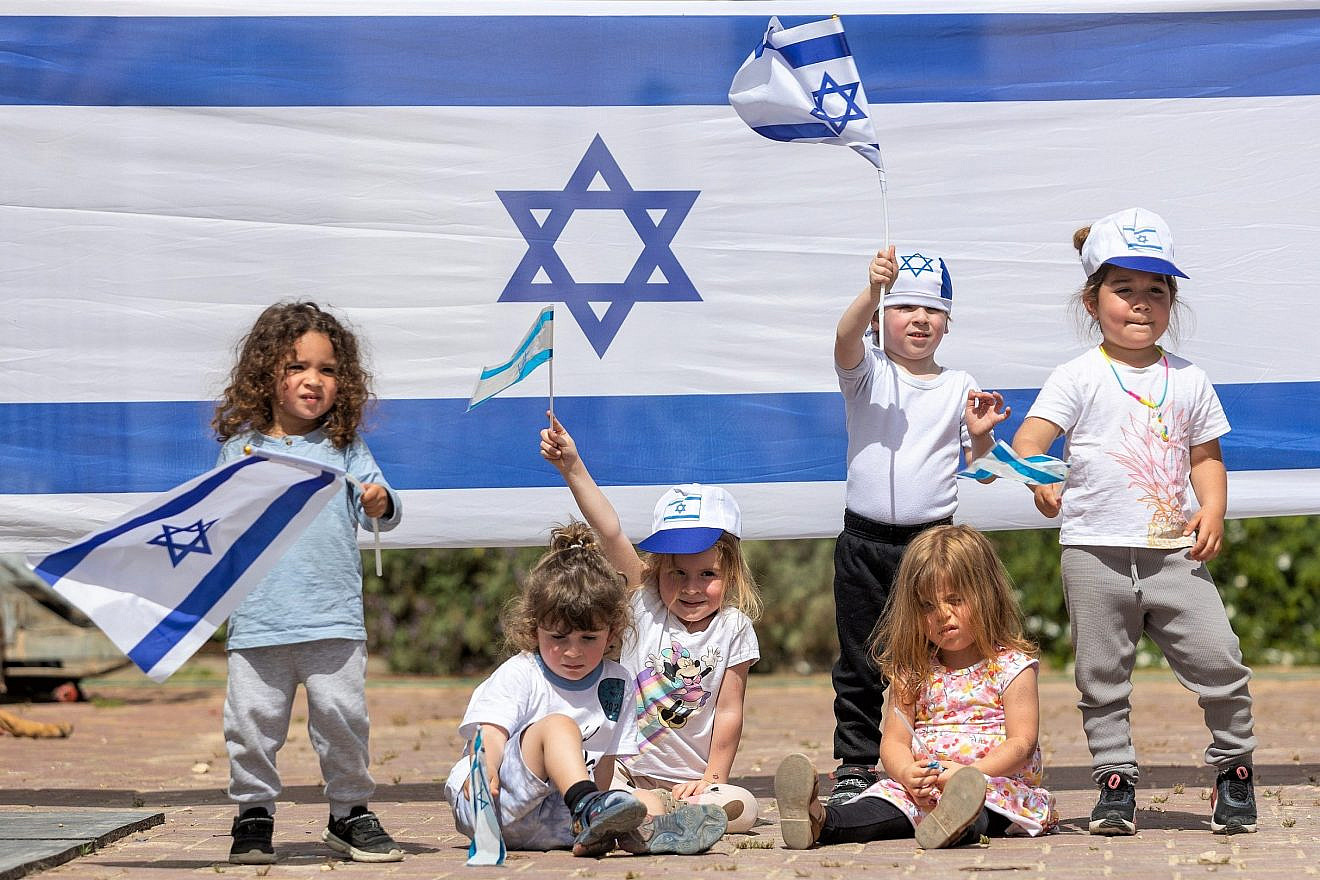 Israeli children play with Israeli flags ahead of Israel's 75th Independence Day, at Kobi kindergarden in Moshav Yashresh, on April 19, 2023. Photo by Yossi Aloni/Flash90.