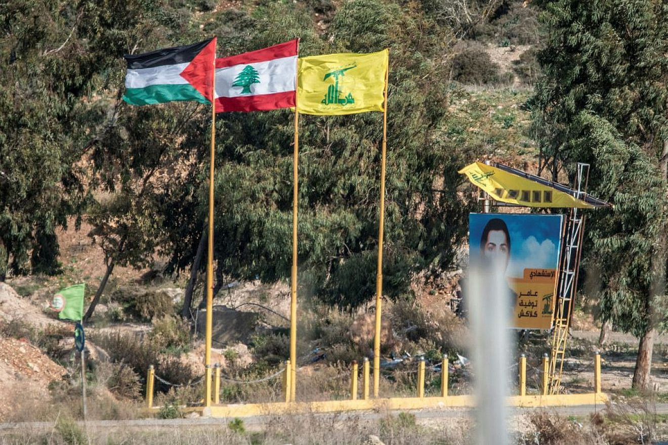 From left, PLO, Lebanese and Hezbollah flags are seen on the Lebanese side of the border near Metula in northern Israel, Dec. 05, 2018. Photo by Kobi Richter/TPS.