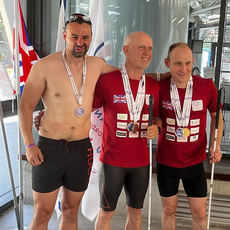 Craig Lundberg (right) receives a swimming medal in the visually impaired category. Courtesy.