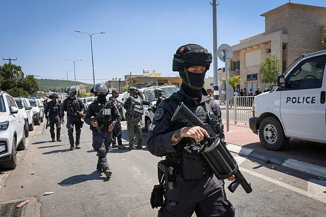 Police stand guard during a protest against the construction of a wind farm near Majdal Shams in the Golan Heights, June 21, 2023. Photo by Ayal Margolin/Flash90.