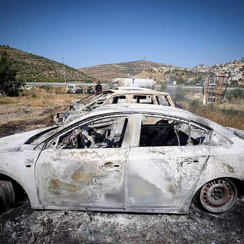 Burned cars in the village of Al-Lubban, next to the Israeli settlement of Eli. Photo by Flash90.