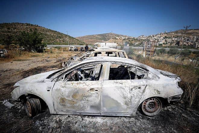 Burned cars in the village of Al-Lubban, next to the Israeli community of Eli. Photo by Flash90.