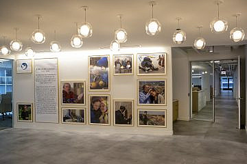 The entrance lobby with a photo wall and memorial to Rabbi Yechiel Eckstein at the new International Fellowship of Christians and Jews headquarters at 303 E. Wacker Drive in Chicago, March 29, 2022. Credit: IFCJ.