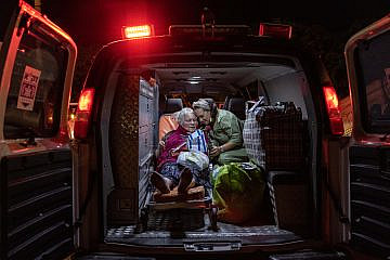 Yael Eckstein in an ambulance with an elderly woman during a ZAKA–IFCJ medical emergency rescue flight on May 8, 2022. Credit: IFCJ.
