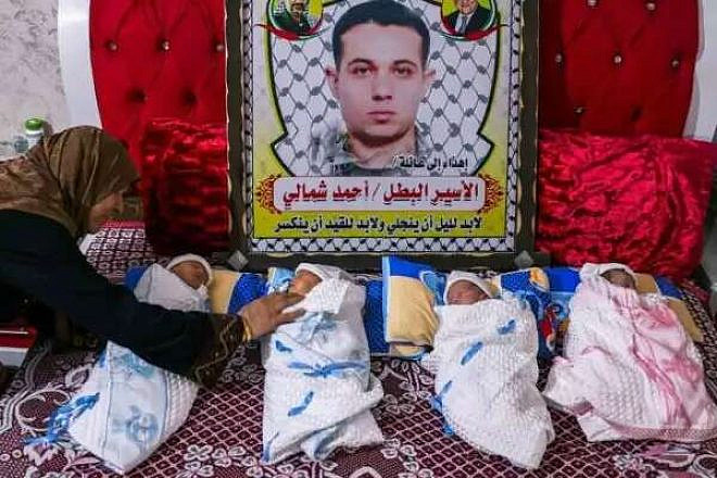 A picture of imprisoned terrorist Ahmad Shamali, together with his four children, conceived with sperm smuggled out of Israel's Nafha prison and into the Gaza Strip. Source: Social media via Israel Hayom.