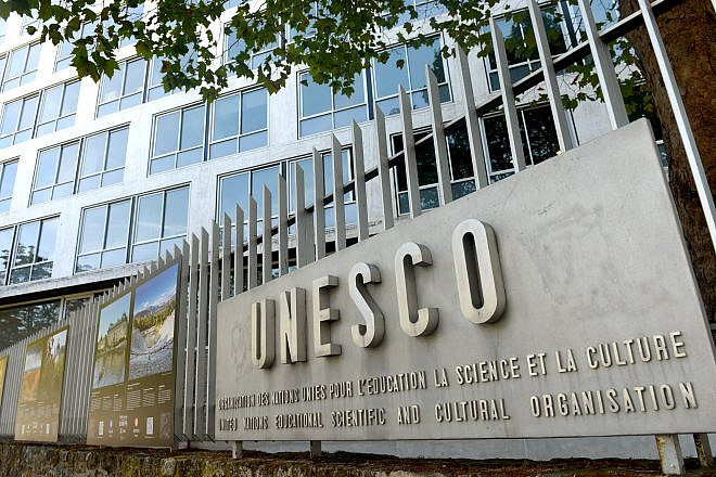The logo of the UNESCO on the main building in Paris, France. Photo by Bumble Dee/Shutterstock.