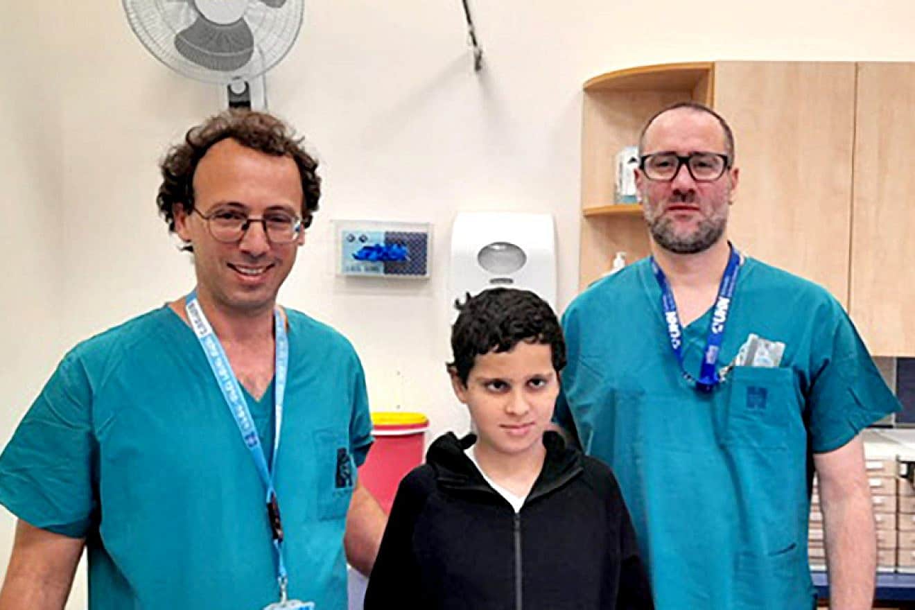 Dr. Ohad Einav and Dr. Ziv Asa with 12-year-old Suleiman Hassan. Credit: Hadassah Medical Center.