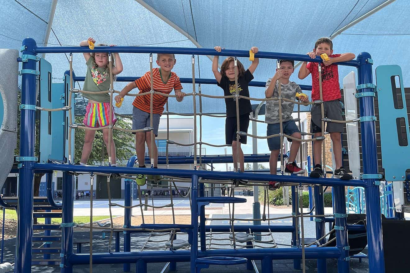 Children at the Pardes Jewish Day School in Scottsdale, Ariz., play on covered equipment, July 2023. Credit: Courtesy.
