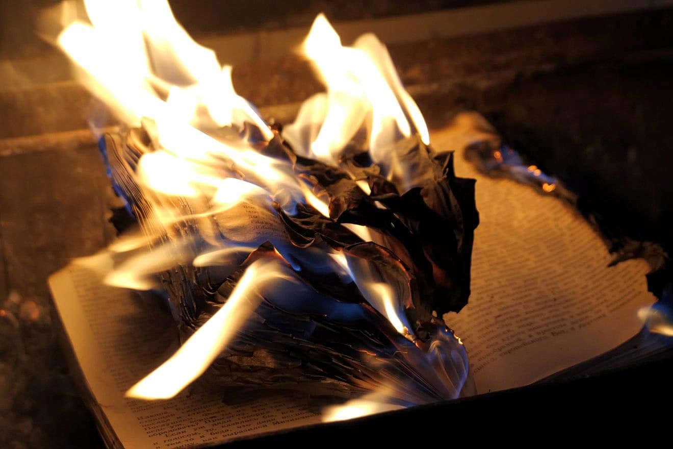An open book on fire. Credit: Sergeyxsp/Shutterstock.