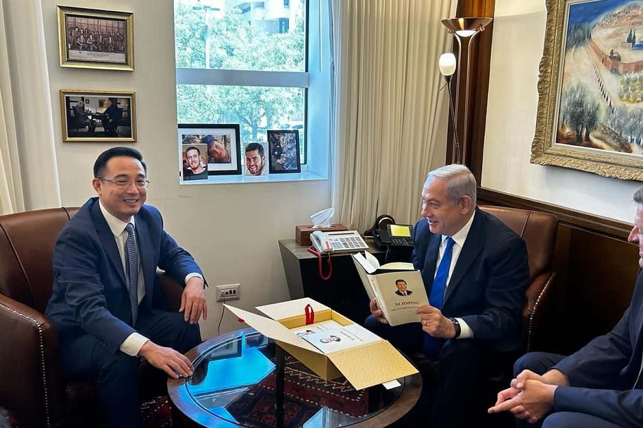 Prime Minister Benjamin Netanyahu holds an autographed copy of Chinese President Xi Jinping's book that Ambassador Cai Run gave him during their meeting in Jerusalem, July 26, 2023. Credit: Prime Minister's Office.