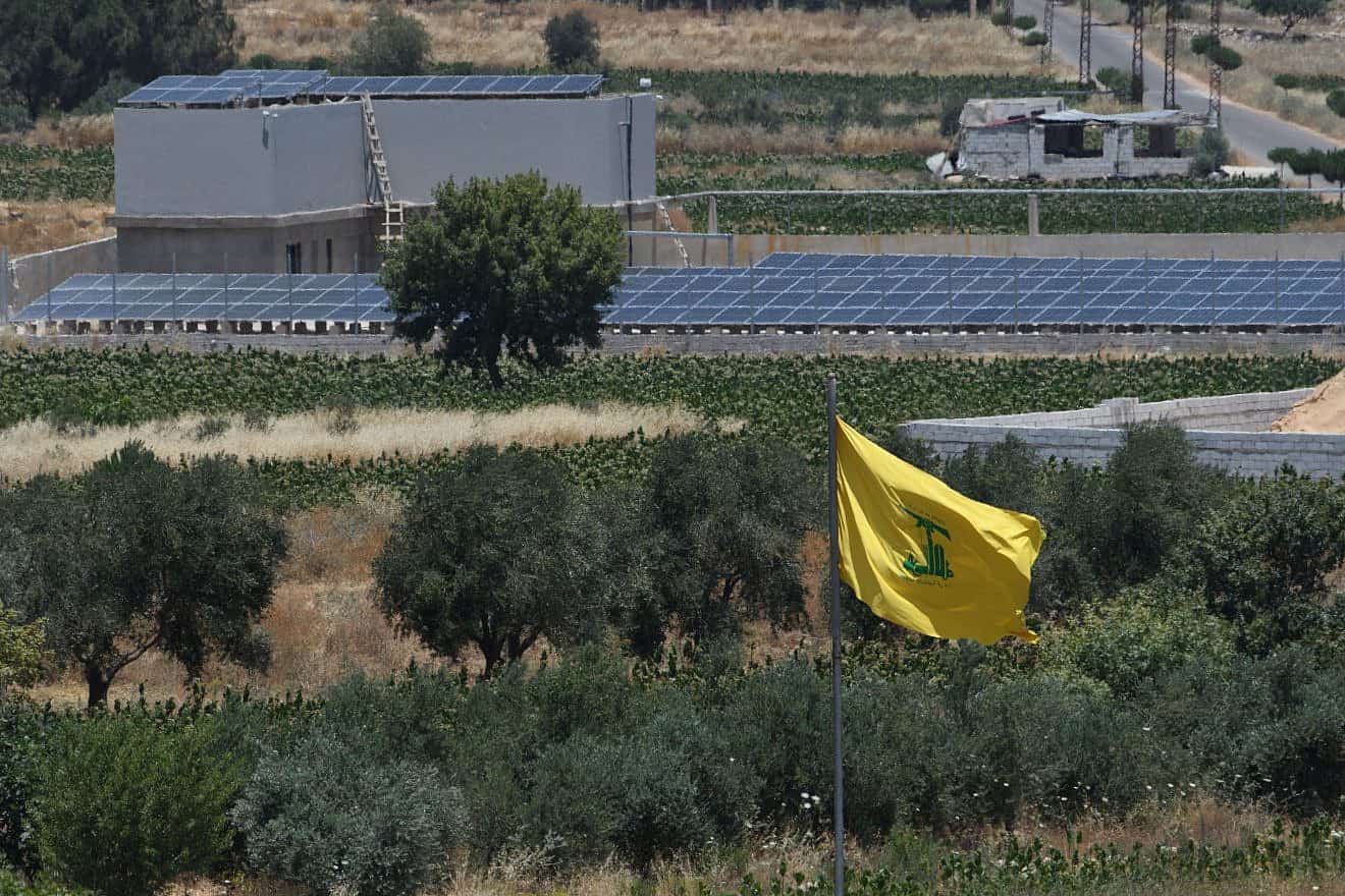 A Hezbollah flag in Lebanon, as seen from the Israeli side of the border, June 27, 2023. Photo by Ayal Margolin/Flash90.