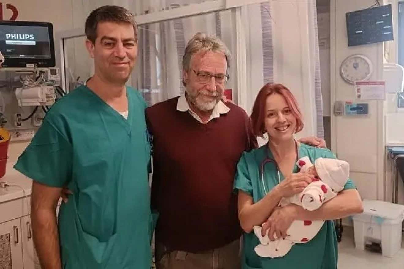 Tamar Levi's daughter with Dr. Shay Porat (left), Dr. Marc Zerah (center) and another medical staffer. Credit: Hadassah Spokesperson.