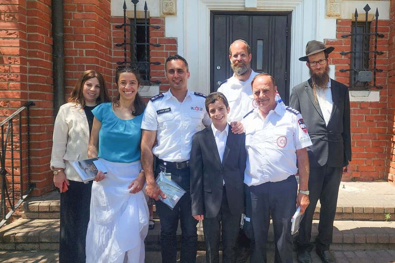 13-year Shmuel Kovetzik (front, center) celebrating his bar mitzvah on July 19, 2023 with his family and the emergency medics who saved his life. Photo by Magen David Adom.